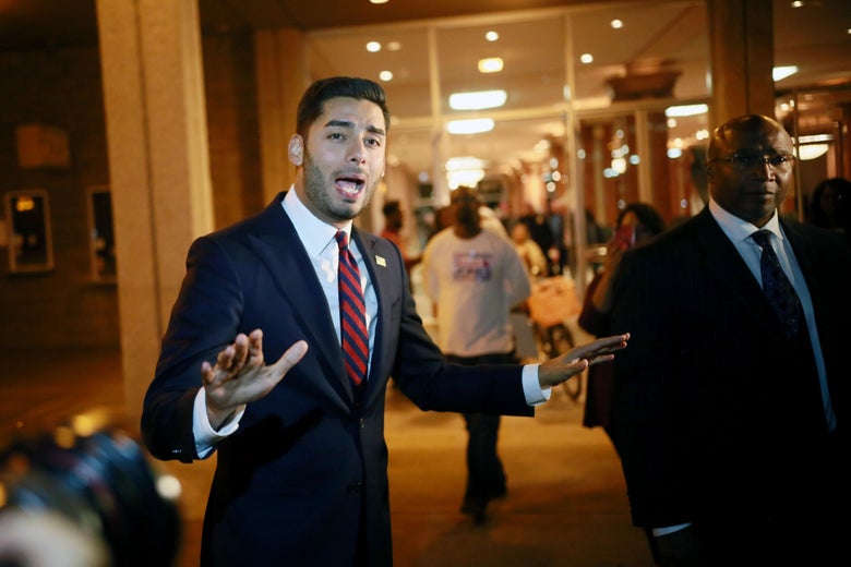 Ammar Campa-Najjar with his hands outstretched.